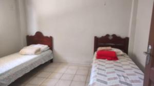 two beds in a small room with at 23 - Este imovel e seu disponha a vontade in Paragominas