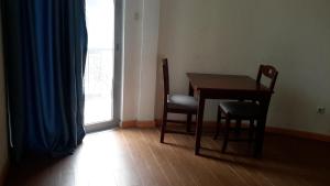 a room with a table and two chairs and a window at Sport Guest House in Addis Ababa