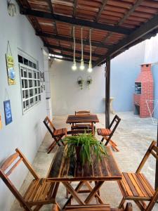 a dining room with wooden tables and chairs at Casa do umbuzeiro in Bom Jesus da Lapa
