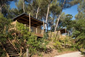 a cabin in the woods with stairs leading up to it at Citykamp d'Aix-en-Provence in Aix-en-Provence