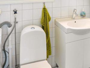 a bathroom with a white toilet and a sink at 4 star holiday home in Dyrön in Stora Dyrön +17 photos