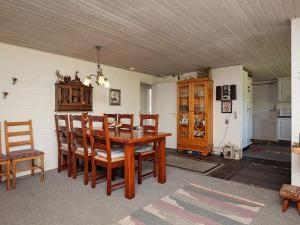 a dining room with a wooden table and chairs at 6 person holiday home in Farsø-By Traum in Farsø