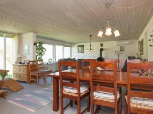 a dining room with a wooden table and chairs at 6 person holiday home in Farsø in Farsø +30 photos