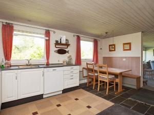 a kitchen with a table and a dining room at 6 person holiday home in Farsø in Farsø