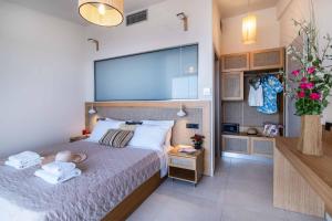 a bedroom with a bed with a large screen above it at Villa Andromeda Sunset in Tsoukalades +28 photos