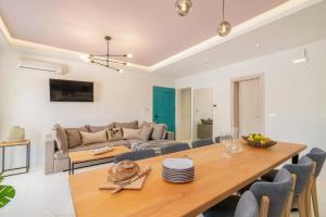 a living room with a table and a couch at Villa Amelina by Villa Plus in Lithakia