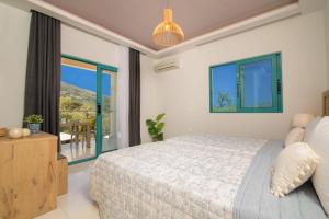 a bedroom with a bed and a large window at Villa Amelina by Villa Plus in Lithakia +20 photos