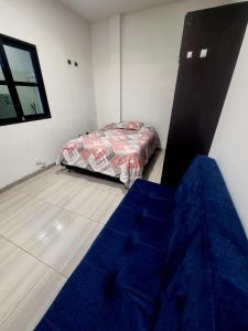 a room with a bed in a room with a beduteneway at Apto, kennedy central amoblado in Bogotá