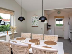 a dining room with a table and chairs at 6 person holiday home in Væggerløse in Bøtø By