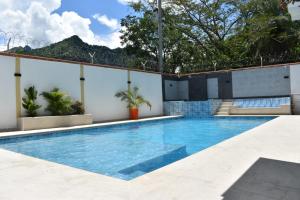 a swimming pool in the middle of a building at hotel bocas del cauca in Tarso