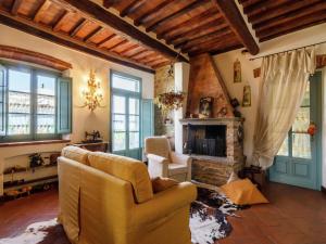 a living room with a couch and a fireplace at Luxury pool villa in Cortona in Cortona +8 photos