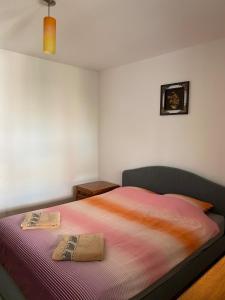 a bedroom with a bed with two towels on it at Lovely entire apartment in Cugir in Cugir