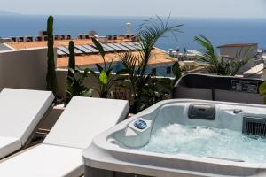 a bath tub sitting on top of a balcony at Astoria Hotel in Agia Galini