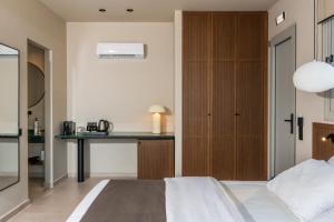 a bedroom with a bed and a desk at Astoria Hotel in Agia Galini +86 photos