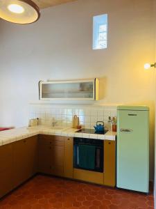 a kitchen with a refrigerator and a sink at Mas Saint Michel in Vivès +16 photos