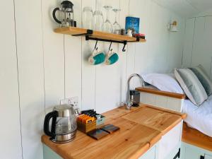 a kitchen with a wooden counter top in a room at Sea Spray in St Austell