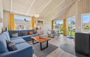 a living room with a blue couch and a table at Strandblick 7 in Schönhagen