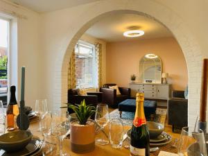 a room with a table with wine bottles and glasses at Large villa opposite beach in Great Yarnouth in Great Yarmouth