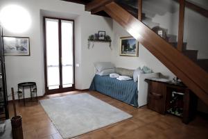 a living room with a bed and a staircase at Villa Brothers' House in Vimercate