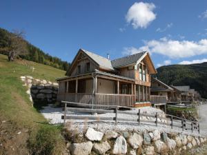 a house on a hill with a stone wall at Chalet Hohentauern am Skilift in Hohentauern