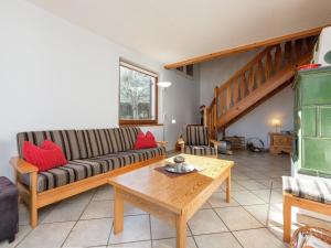 a living room with a couch and a table at Holiday Home in Groebming near Ski Slopes in Gröbming