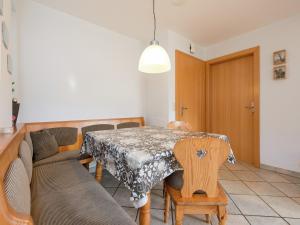 a living room with a table and a couch at Holiday Home in Groebming near Ski Slopes in Gröbming