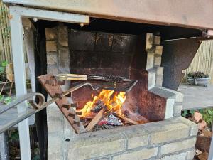 a brick oven with a fire in it at Duinland 142 in Sint Maartensvlotbrug