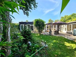 a house with a garden in front of it at Duinland 142 in Sint Maartensvlotbrug