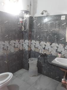 a bathroom with a toilet and a sink at Hotel Airport Shine Inn in Hyderabad