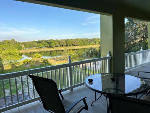 a balcony with a table and chairs and a view of a river at River Resort in Tampa