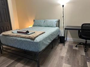 a bedroom with a bed with a table and a desk at River Resort in Tampa