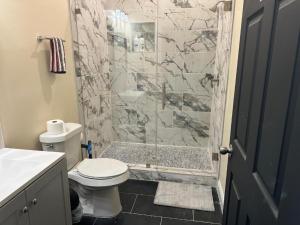 a bathroom with a shower with a toilet and a sink at River Resort in Tampa
