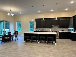 a large kitchen with black cabinets and a table and chairs at River Resort in Tampa