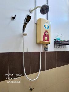 a shower in a bathroom with a shower head at nearby umt unisza hosza litar gong badak airport chelong homestay kuala terengganu in Kampong Bukit Berangan