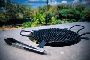 a grill and two tongs sitting on a table at ZenBreak The View Studio in Cap Estate