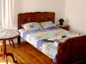 a bed in a room with a table and a bed sidx sidx sidx at Granpa's House in Ruhovtsi