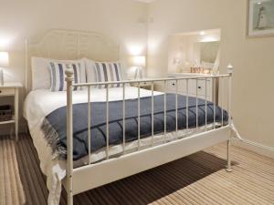 a bedroom with a white bed and a mirror at The Snug, Lynmouth - Uk41696 in Lynmouth