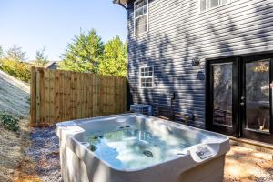 a hot tub in a yard next to a house at Peaceful Getaway Hot Tub Perfect Location in Sevierville