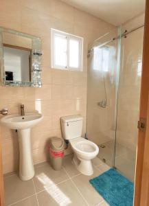 a bathroom with a toilet and a sink and a shower at Apartment near the airport in Boca Chica