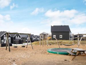 an empty playground with a swing set and houses at 8 person holiday home in Gjern in Gjern +20 photos