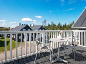 a patio with a table and chairs on a deck at 8 person holiday home in Gjern in Gjern