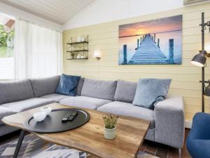 a living room with a couch and a table at 5 person holiday home in Aabenraa-By Traum in Aabenraa +25 photos
