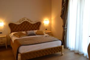 Postel nebo postele na pokoji v ubytování Agriturismo De Luca