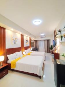 a bedroom with two beds and a living room at Wind Residences Tagaytay Tower 3 in Galicias +35 photos