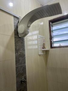 a shower with a shower head in a bathroom at 1bedroom Nyali in Nyali +70 photos