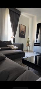 a living room with two beds and a couch at Luxury apartment in Muscat