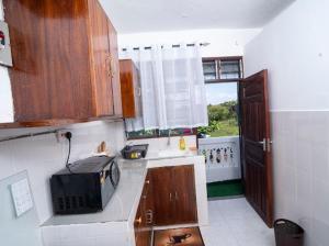 a kitchen with a microwave on a counter top at 1bedroom Nyali in Nyali