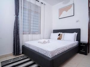 a bedroom with a bed with two teddy bears on it at 1bedroom Nyali in Nyali