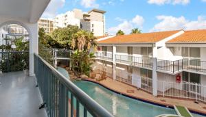 a balcony of a hotel with a swimming pool at Coastal Scarborough Beach Chic Pool View 2BR in Perth