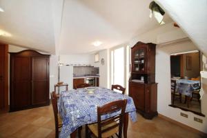 a kitchen and dining room with a table with a blue table cloth at Terrazza sul mare in Santo Stefano di Camastra